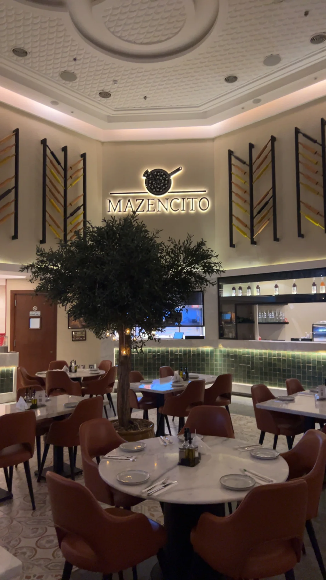 Dining room with an illuminated sign and tree centerpiece