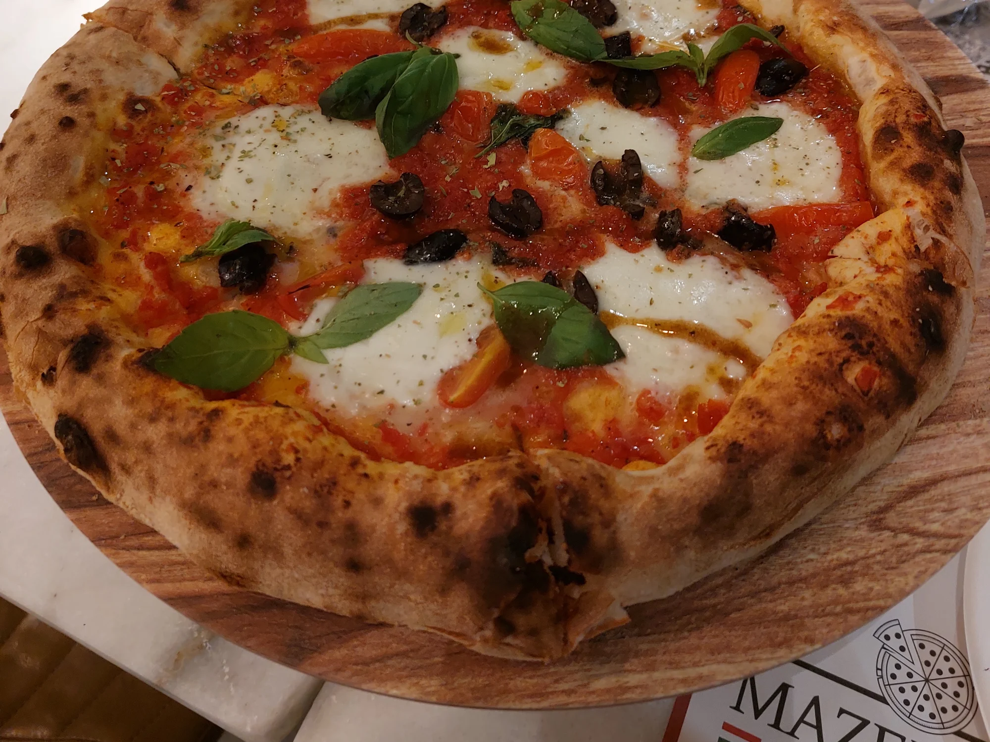 Mazencito Special pizza topped with roasted vegetables and olives