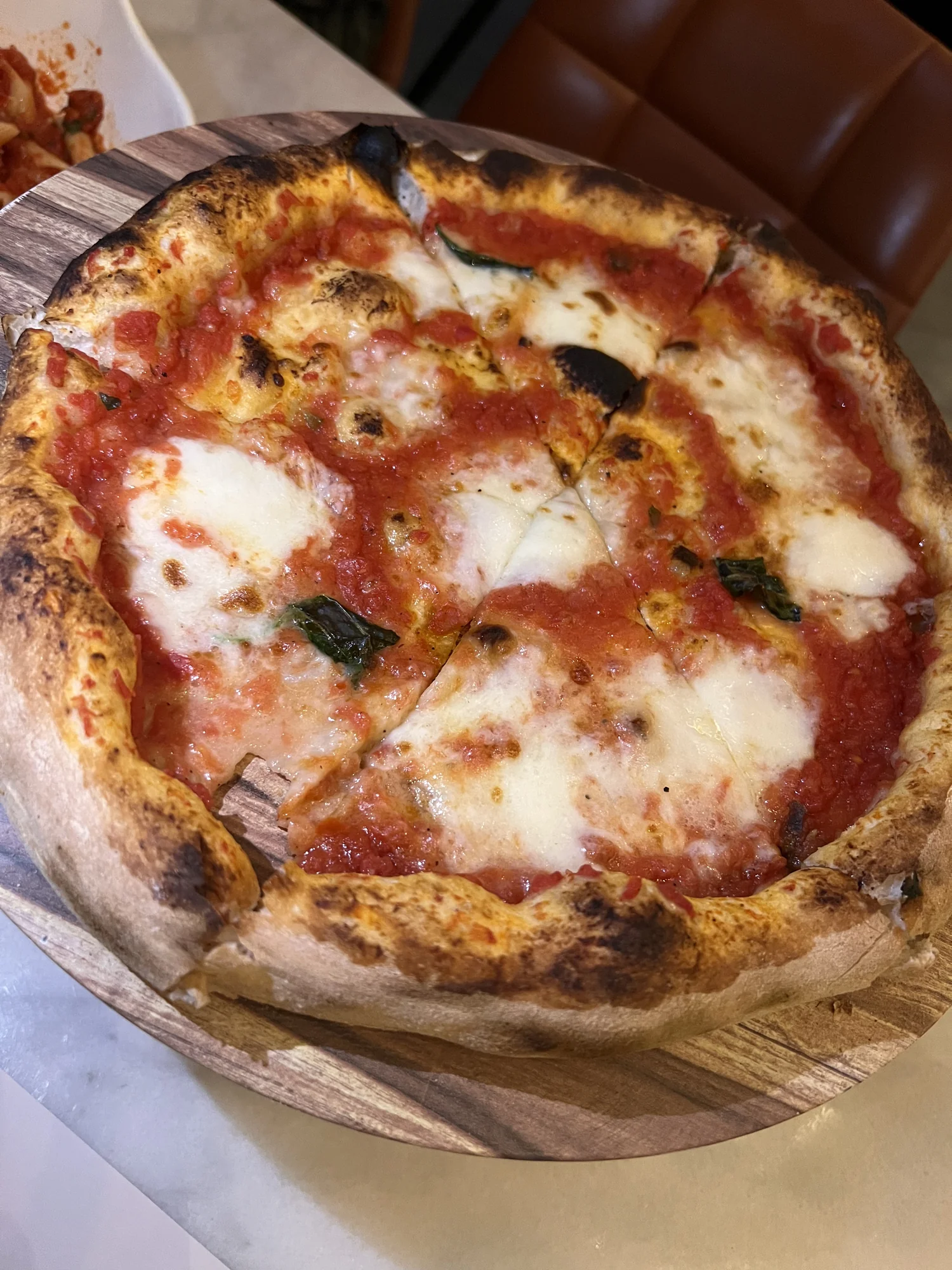 Margherita pizza with fresh mozzarella and basil at Mazencito Pizzeria