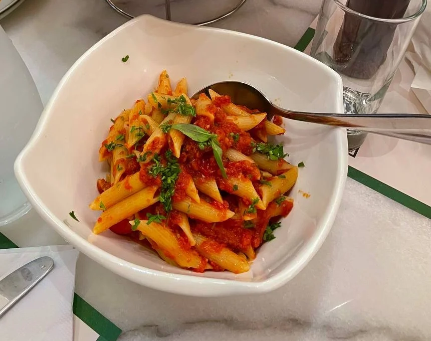 Penne pasta in a spicy tomato sauce with chili flakes