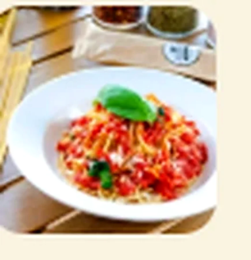Spaghetti tossed in tomato sauce with fresh basil