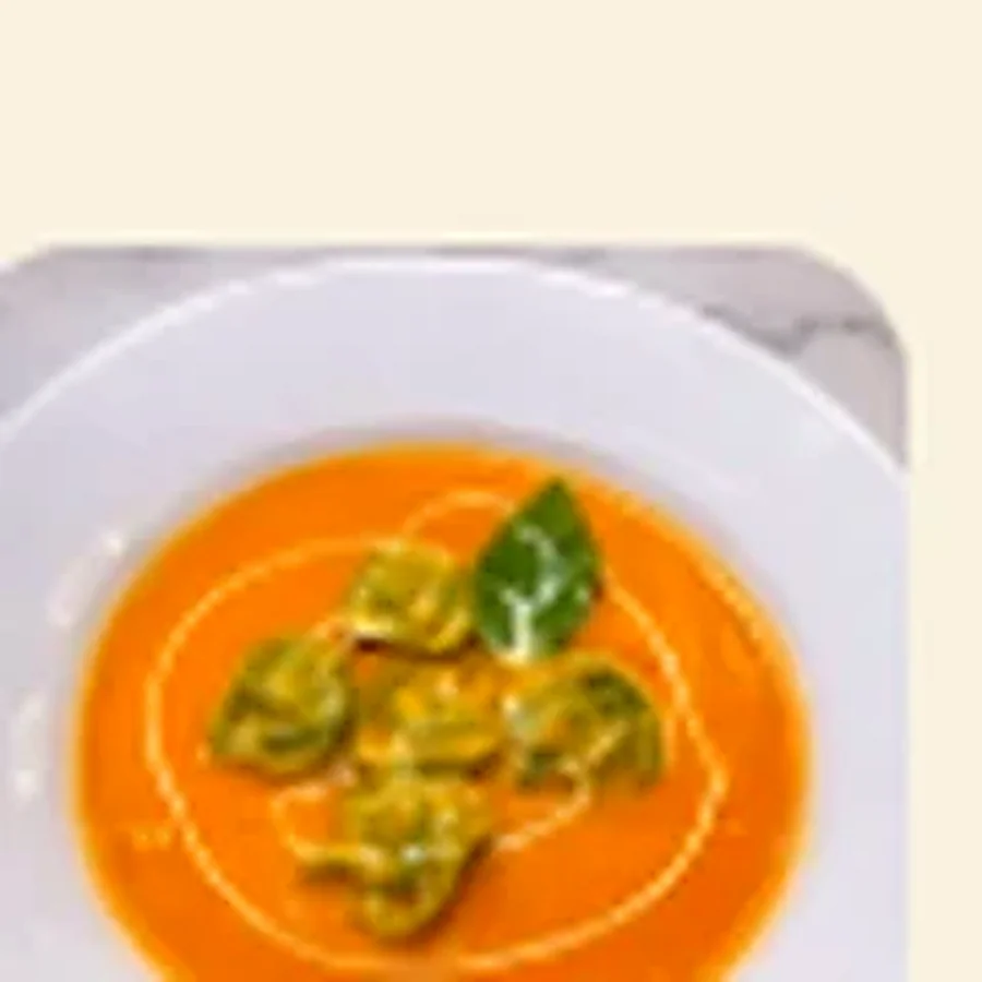 Tortellini filled with goat cheese in a warm tomato soup